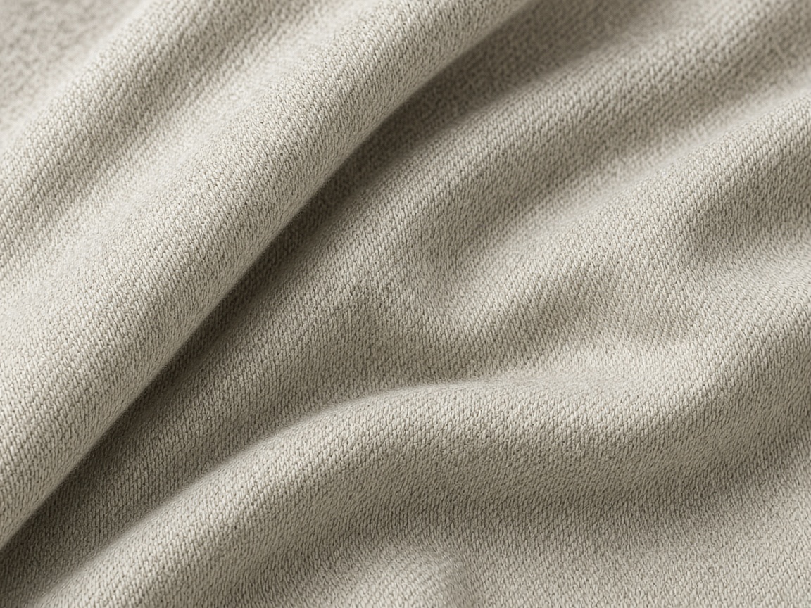 Folded light gray jersey knit showing a fine stitch. Illustrative image, not ETECJK inventory or a facility.